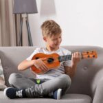 Buy 17 Inch Kids Ukulele Guitar with 4 strings, picks, and classical design. Perfect musical instrument toy for children’s learning, fun, and early music education.